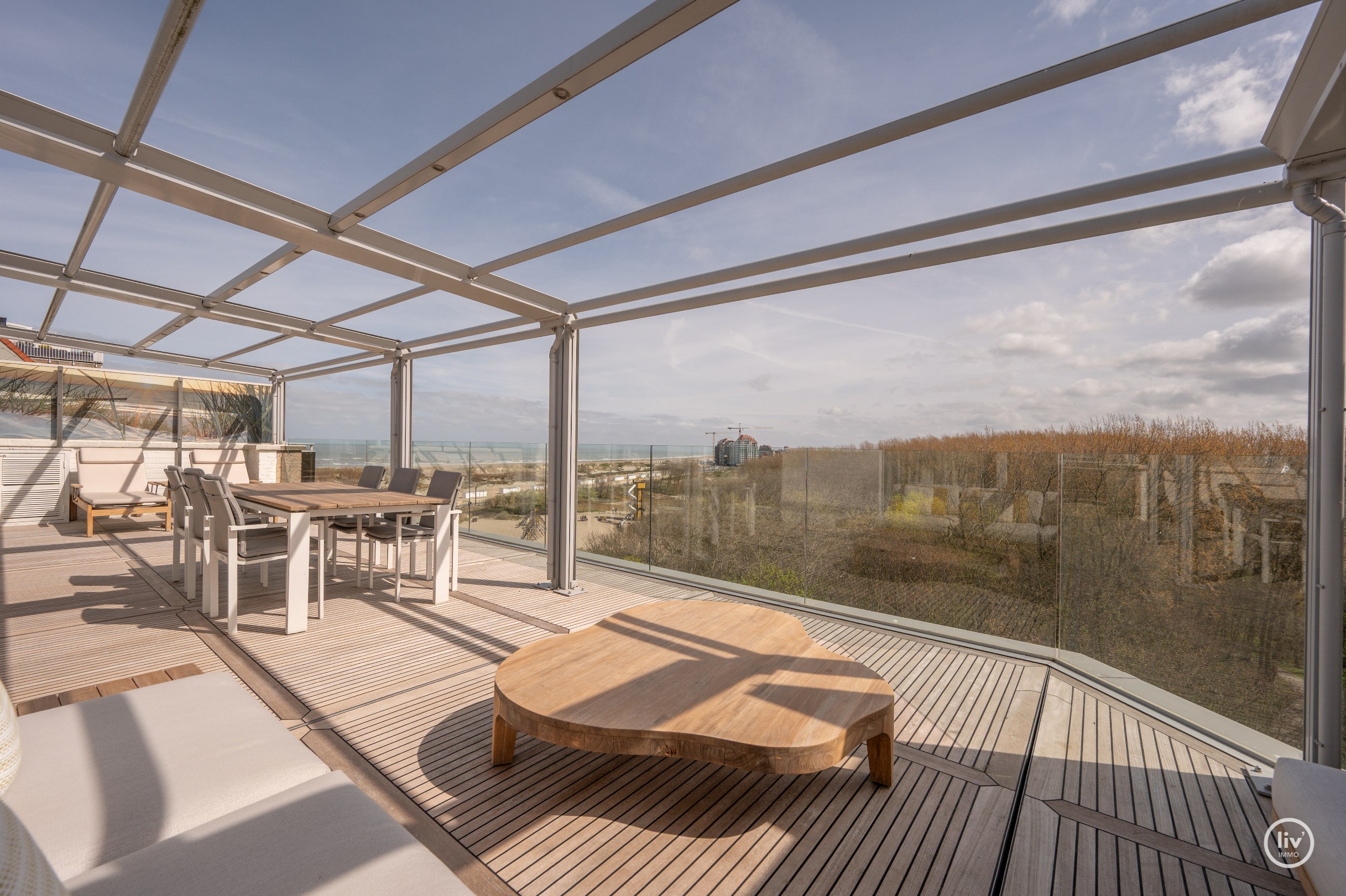 Dit magnifieke duplexappartement combineert uitzonderlijke volumes met adembenemende zichten over zowel de omliggende bossen als de zee. 