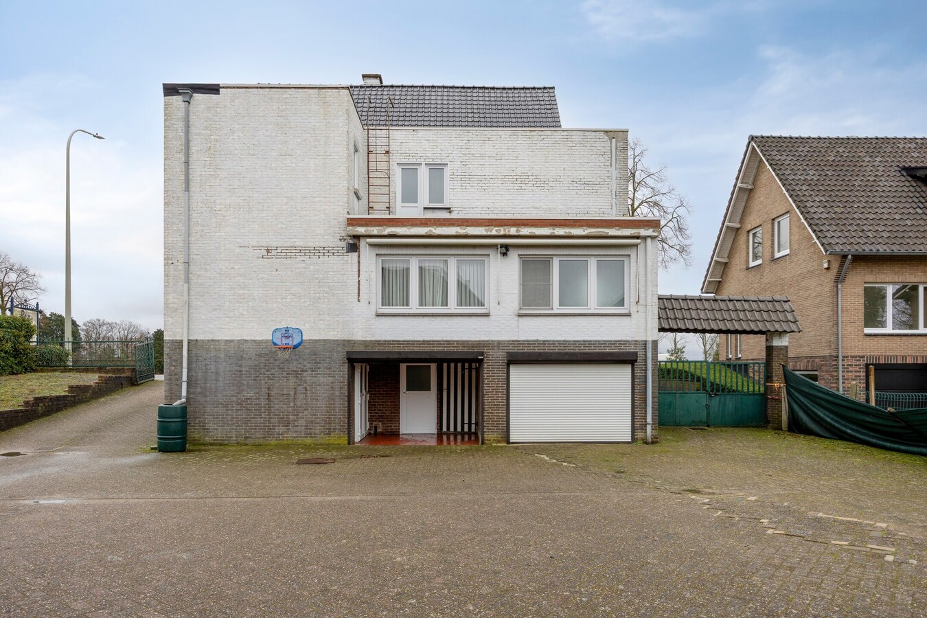 Woning met vergunde loods (300 m² x 2) en bijgebouw (50,50 m²). 