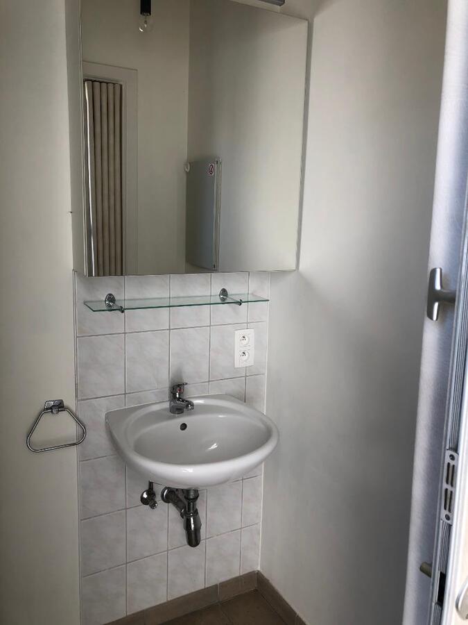 Tijdloos dakappartement met bijzonder ruim terras in centrum Gavere 