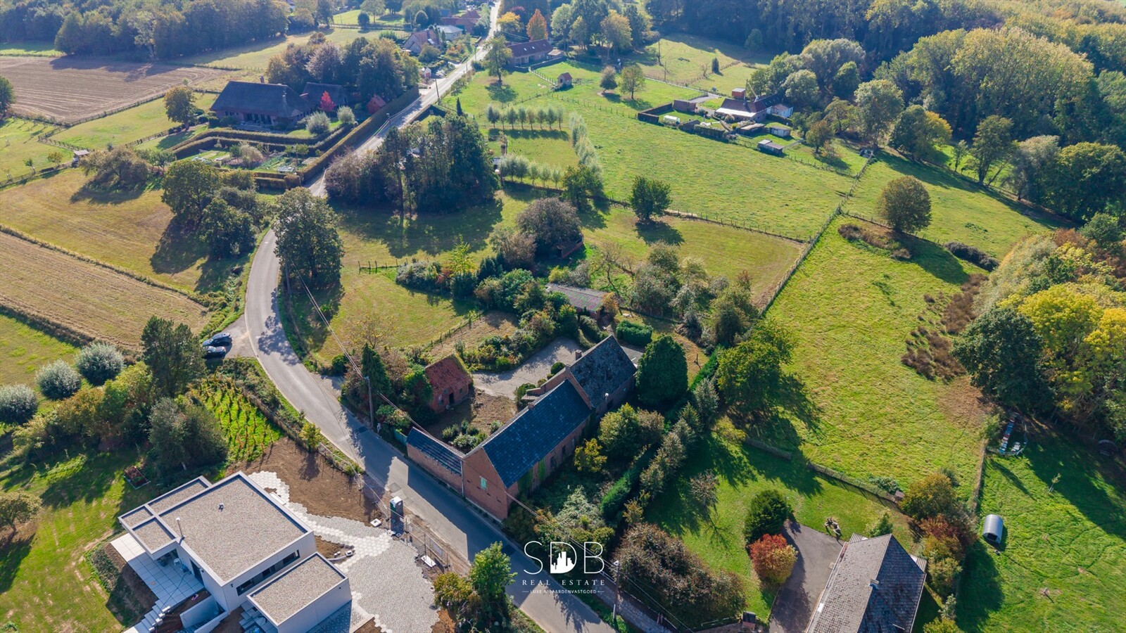 Landelijke hoeve met bijgebouwen en aanpalende graslanden op 14.677m² 