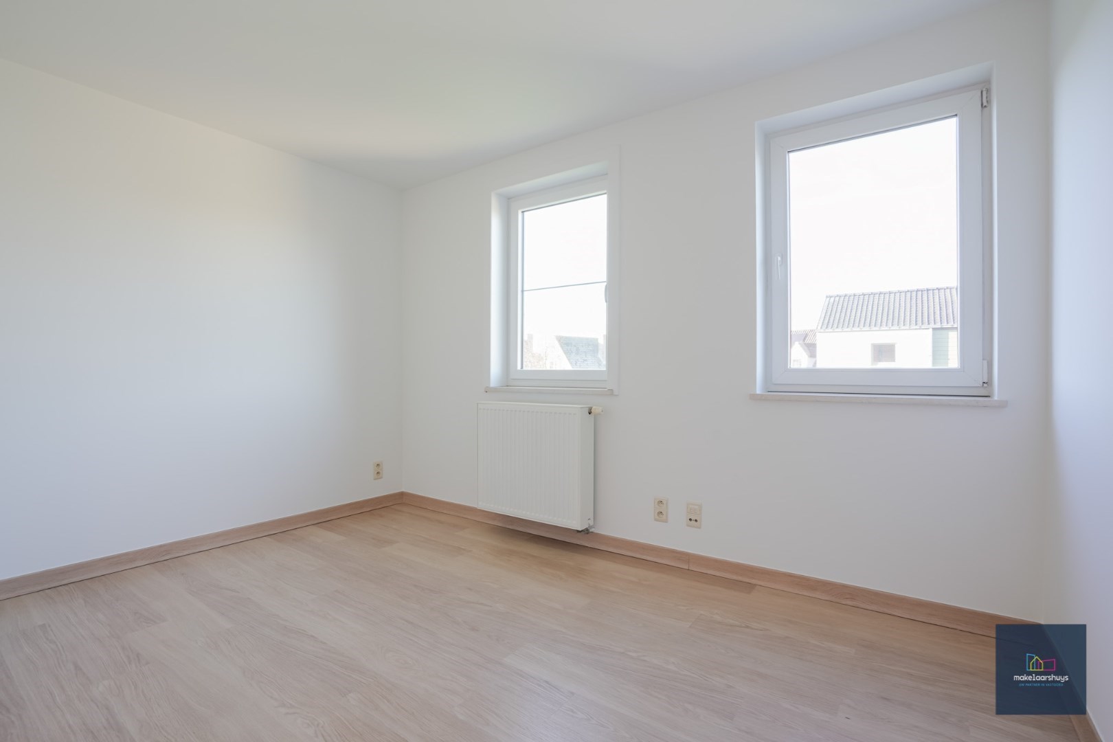 Ruime half-open bebouwing te Heusden met garage en tuin 