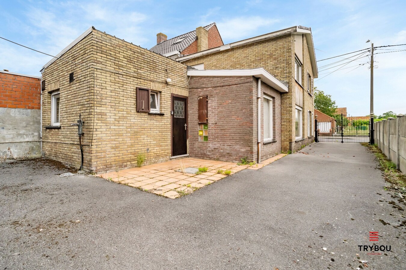 Centraal gelegen, halfopen woning met kleine loods en garage. 