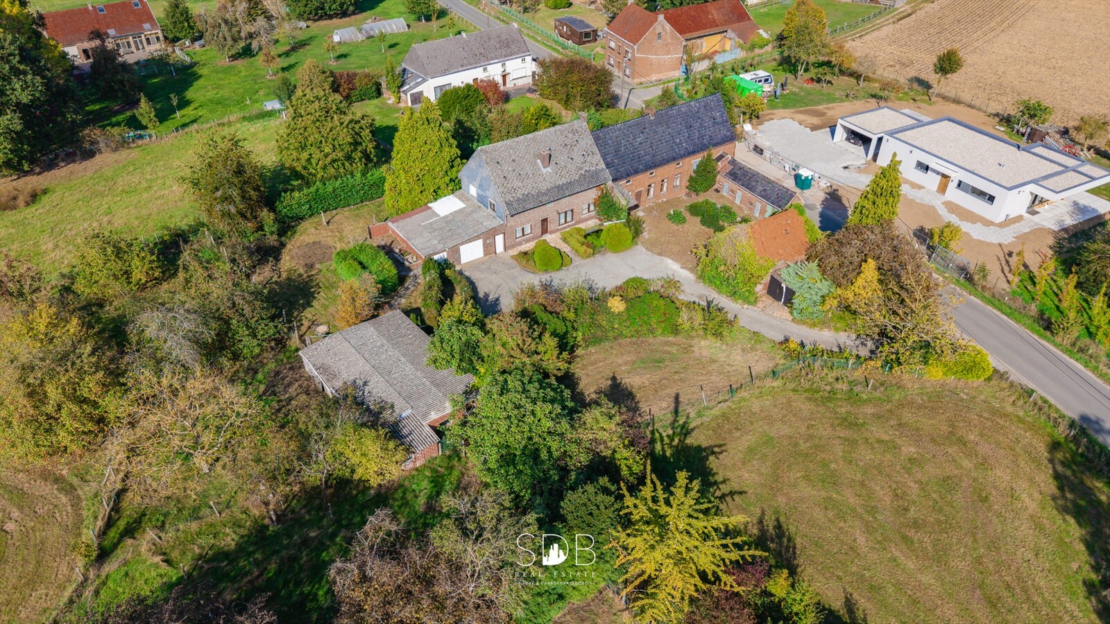 Landelijke hoeve met bijgebouwen en aanpalende graslanden op 14.677m² 