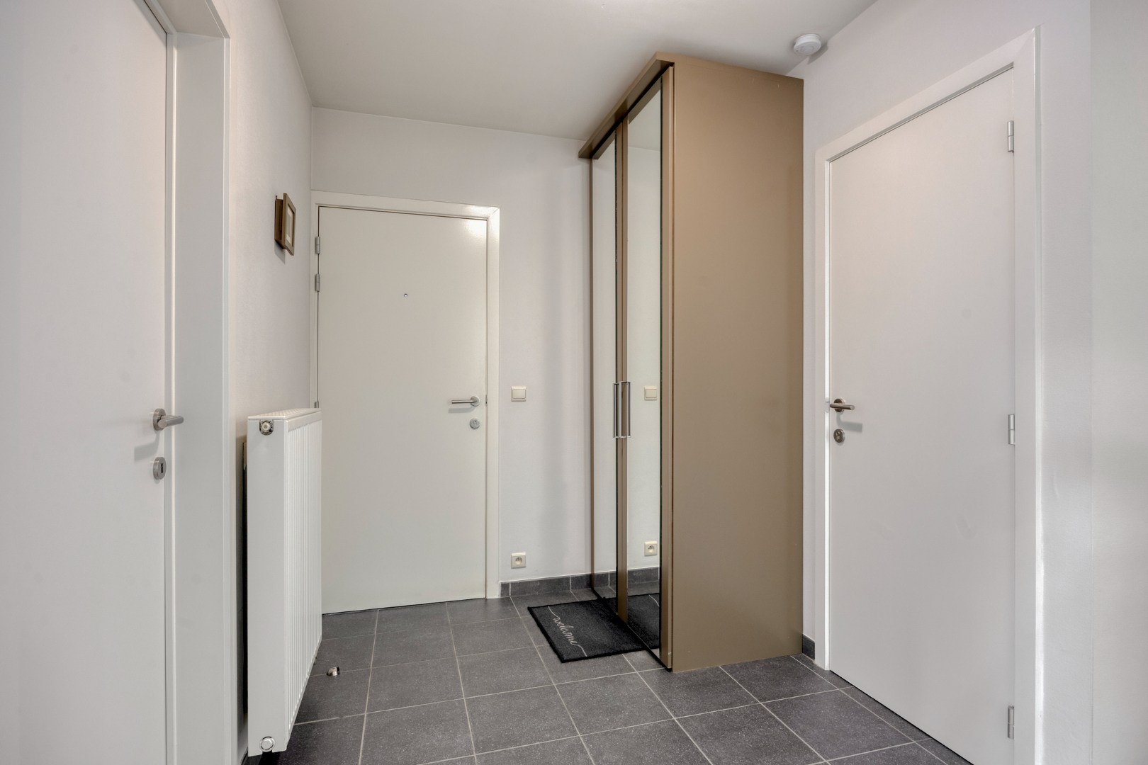 Gelijkvloers appartement met 2 slpk, 2 parkings en 2 kelderbergingen. 