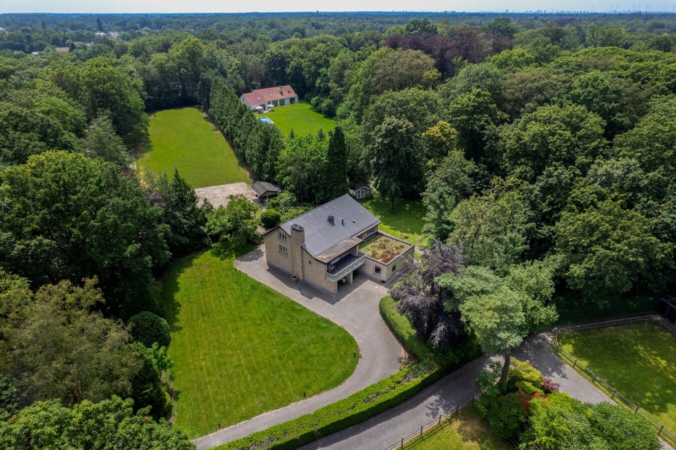 Exclusief eigendom met twee volwaardige, zelfstandige villa-woningen, een conciërgeverblijf en luxueuze paardenfaciliteiten op ruim 2 ha te Brasschaat 